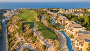 A golf course with a swimming pool and villas. - Theseus Village -2 Bed Apartment With Pool View, Aphrodite Hills Resort, Kouklia (Kouklia)