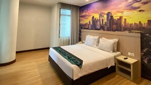 A hotel room with a bed, a nightstand, a cityscape mural, and a window with curtains. - GiiA Sanno Hotel Pluit Jakarta (Jakarta)