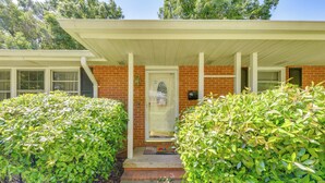 A brick house with a white porch and a door. - 4 Mi to Nascar Hall of Fame: Charlotte Gem w/ Yard (Charlotte)