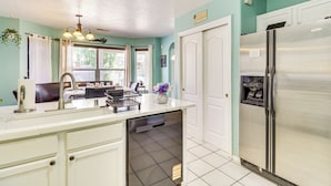 A kitchen with a dishwasher, refrigerator, and a sink with a faucet. - Balloon Fiesta Base in Abq's Ventana Ranch (Albuquerque)