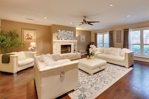 Relax in this inviting living room with a fireplace, plush sofas, and a cozy atmosphere.