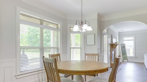 A dining room with a round wooden table, four chairs, and a chandelier. - 9 Mi to Trilith Studios: Gem in Fayetteville! (Fayetteville)