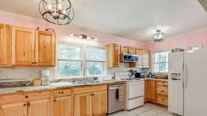 A kitchen with wooden cabinets, a stainless steel refrigerator, a dishwasher, and a microwave. - Home 1 Mi to Dtwn Conway: Great for Beach Days! (Conway)
