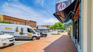 A street with a parked van labeled "Yale Service" and a brick sidewalk. - Walkable Townhome: 'M on Main' in Wytheville (Wytheville)