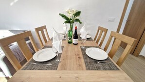 A dining table with two plates, a bottle, and a glass. - COMPLETE APARTMENT WITH TERRACE (Mondariz)