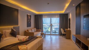A modern hotel room with a large bed, a sofa, a desk, and a TV. - Rewaya Majestic Resort (Hurghada)