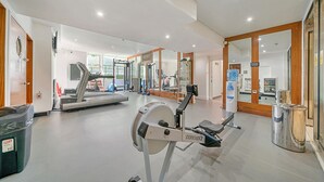 A gym with cardio machines, weight equipment, and a water dispenser. - Roland House - Deluxe Studio (London)