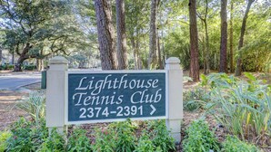 A sign for Lighthouse Tennis Club with a phone number. - Sunset Rentals | Lighthouse Tennis 2387 (Hilton Head Island)