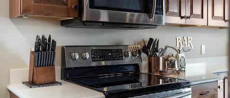 Enjoy cooking in this well-equipped kitchen with a microwave, oven, and stove.