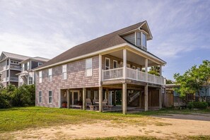 A two-story house with a balcony, a covered porch, and a visible number 1120.