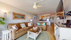 A modern living room with a sofa set, a coffee table, and a TV.