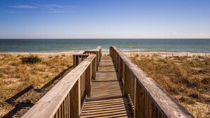 A wooden boardwalk leading to a beach with a clear view of the ocean. - Pelican Watch 907-Lovely end unit with views galore and elevators (Carolina Beach)
