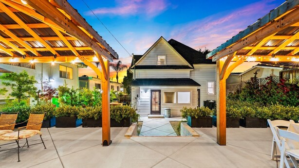 A house with a covered patio, a small pool, and potted plants. - Perfect 4 Families, Mins 2 Beach, Amazing Backyard (Ventura)
