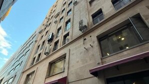 A multi-story building with a beige facade, large windows, and air conditioning units. - Prime City Residence by Sweet Home (Yerevan)