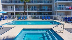 A pool area with two pools, lounge chairs, and a palm tree. - ⭐Gulf Views-Hot Tub-Private Balcony-1BR+Bunk Summerspell 303⭐ (Miramar Beach)