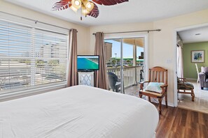 A hotel room with a bed, a television, a chair, and a view of the outside. - 🌞Private Path to Beach~3BR St Martin Beachwalk Villas 221 (Destin)