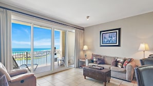 A spacious living room with a large sliding glass door leading to a balcony with a view of the ocean. - ☀️By Beach in Seascape-16th FL Gulf Views-3 Pools-Ariel Dunes II 1606☀️ (Miramar Beach)