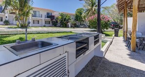 Enjoy al fresco dining in a serene courtyard setting with a sink and grill.