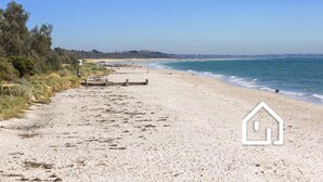 A beach with a wooden walkway, clear skies, and a distant pier. - Lookout & Sea *1 NIGHT FREE* Beachfront Bliss in McCrae (McCrae)