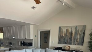 A modern living room with a grey sectional sofa, a wooden coffee table, and a patterned rug.