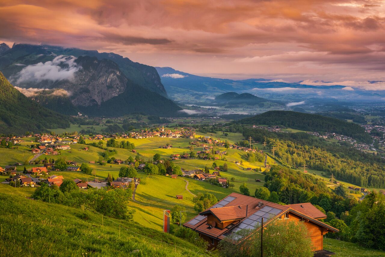 A mountainous landscape with a village nestled in the valley.
