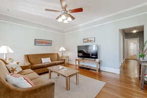 Relax in this inviting living room with a comfortable sofa, flat-screen TV, and stylish coffee table.