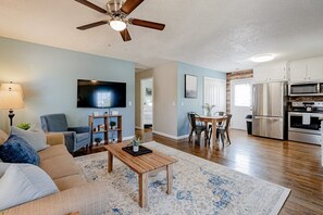 Relax in this open-plan living space with a flat-screen TV and dining area near the kitchen.