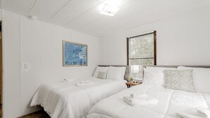 A hotel room with two beds, white bedding, a framed artwork on the wall, and a window with blinds. - Mins to Downtown & Working Desk - Gamecock Roost (West Columbia)