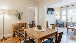 A dining area with a wooden table, chairs, a lamp, and a potted plant. - Mins to USC, Hospital, Zoo! Columbia Duet-Unit A (West Columbia)