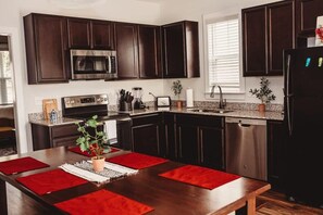 Enjoy cooking in this well-equipped kitchen with a large island, microwave, oven, and dishwasher.