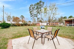 Relax on the patio surrounded by lush greenery and enjoy the serene atmosphere.