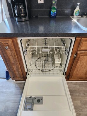 Kitchen equipped with a dishwasher and coffee maker.