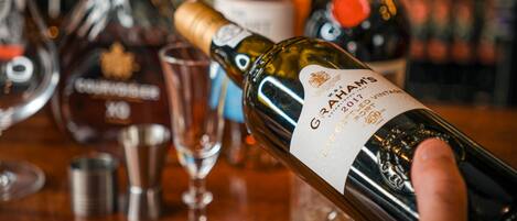 A hand holding a bottle of Graham's 2017 Late Harvest Port.