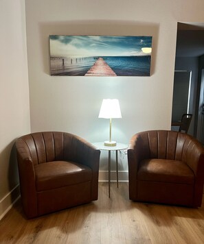 Relax in a serene space with two comfortable armchairs and a stylish table.