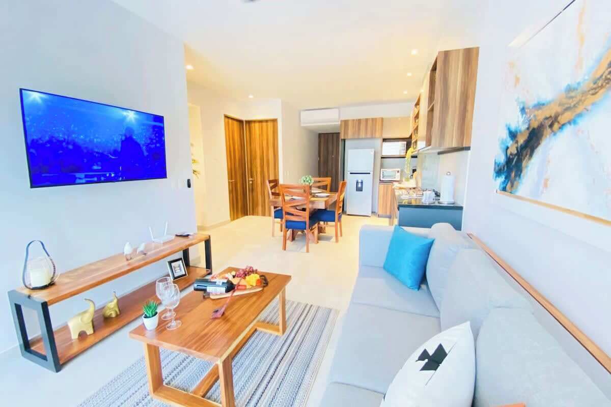 The sitting area features a comfy sofa and Smart TV