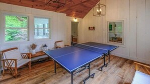 A room with a ping pong table, wooden chairs, and a wooden ceiling. - Large Farmhouse Steps from Downtown Ludlow & Okemo Shuttle (Ludlow)
