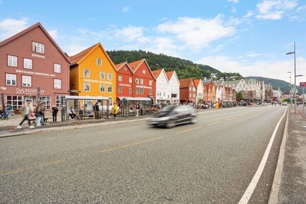 A street lined with colorful buildings, including a hotel and a restaurant.