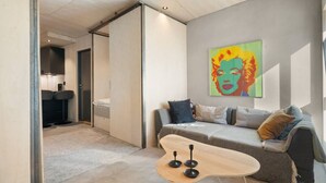 A modern living room with a sofa, a coffee table, and a colorful artwork on the wall. - The Double Date I  Architectural (Bergenhus)