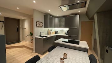 Fridge, stovetop, dishwasher, coffee/tea maker