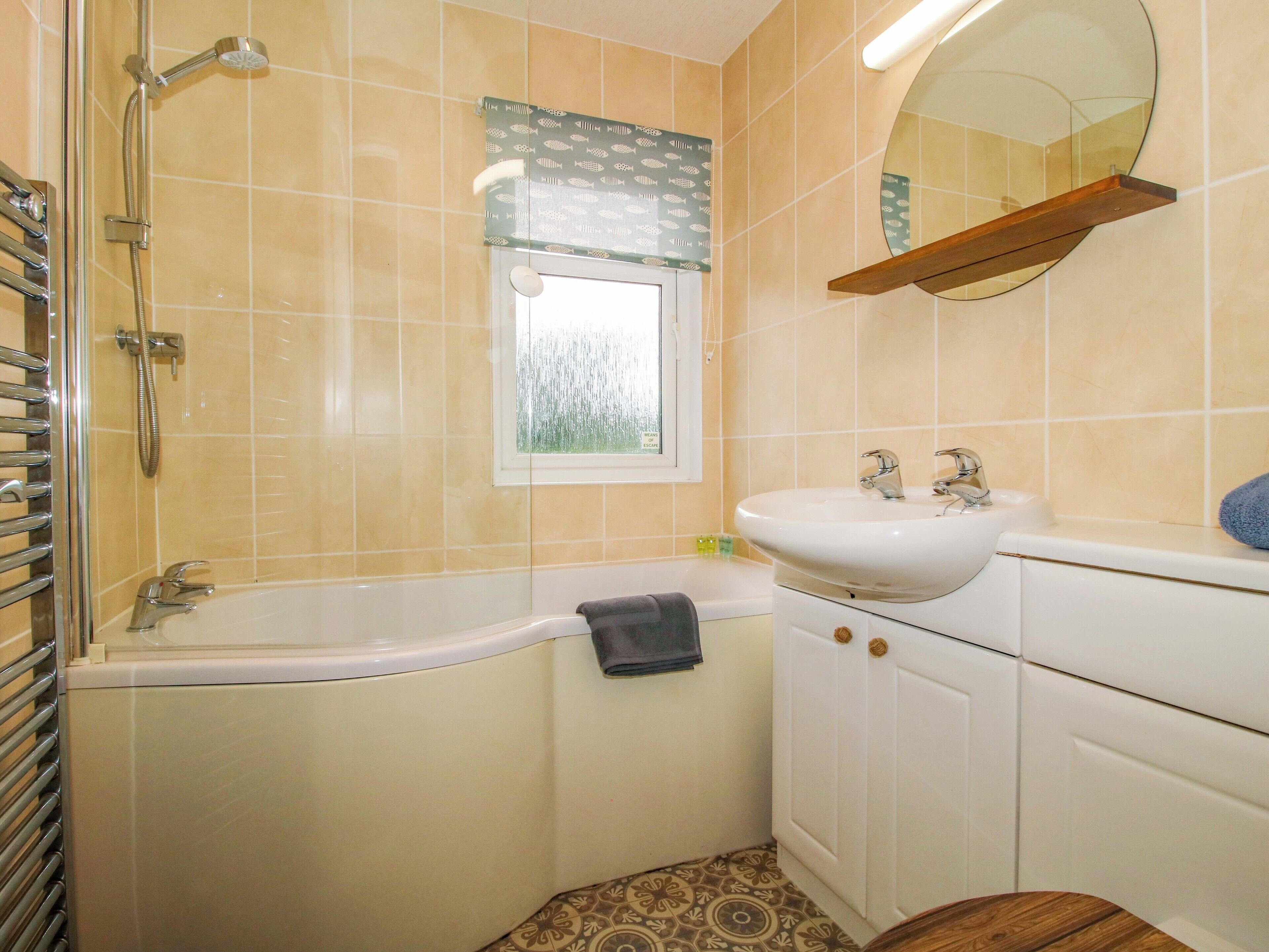A bathroom with a bathtub, a sink, and a shower.