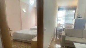 A hotel room with a bed, a desk, and a chair. - Sea View Apartment in Durres Albania (Durrës)