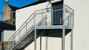 A metal staircase leading to a white building with a metal railing. - Viewforth Studio No.4 (Fort William)