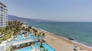 A resort with a pool, beach, and ocean view.