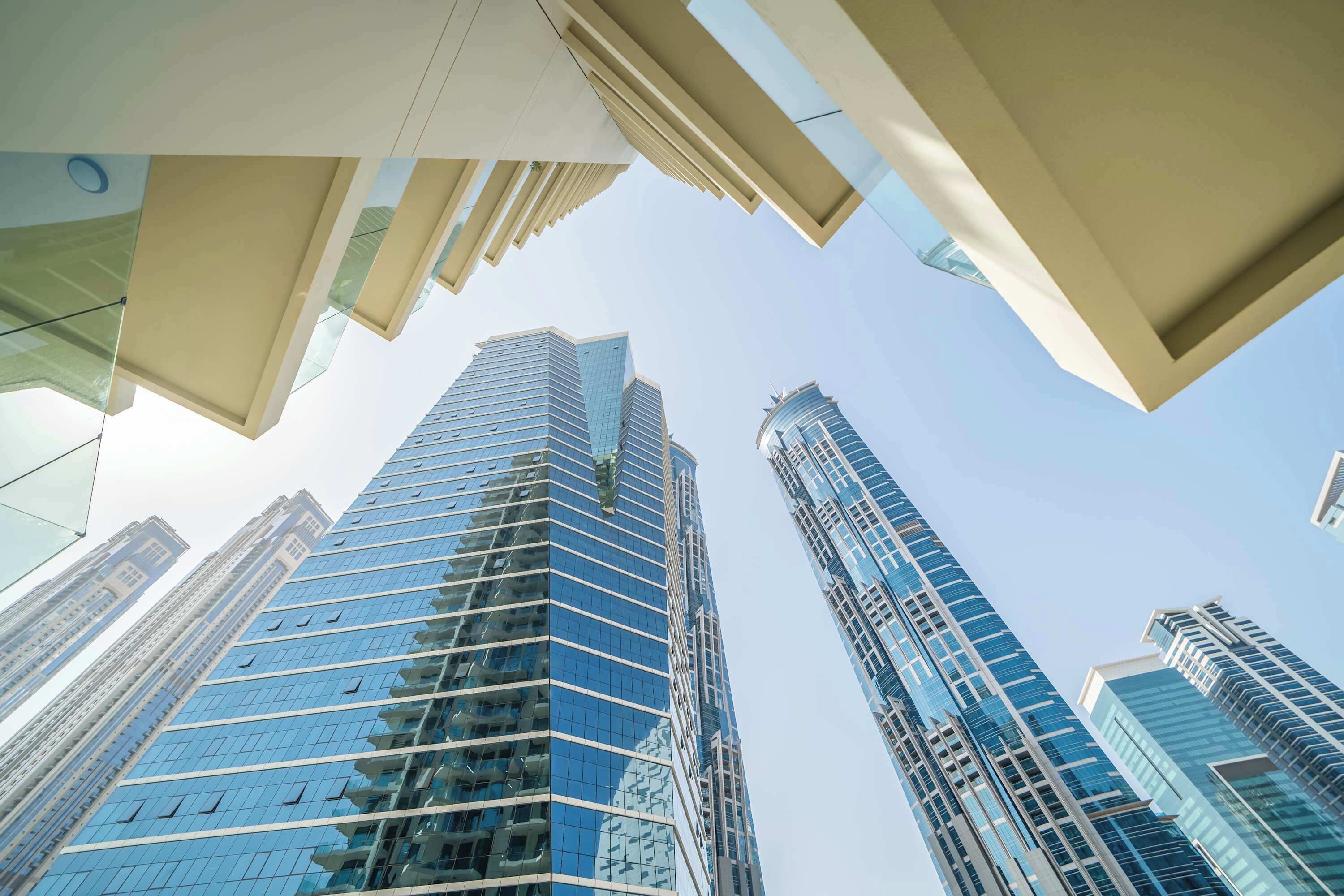 A high-rise building with a modern glass facade and a unique architectural design.