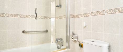 A bathroom with a glass shower enclosure, a white toilet, and a bathtub.