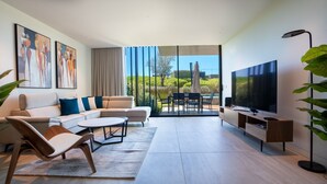 A modern living room with a sofa, chairs, a TV, and a view of the outdoors. - Cloud9 by LovelyStay | Heaven with Private Pool (Funchal)