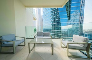 A modern living room with a glass balustrade, a sofa, and a coffee table.