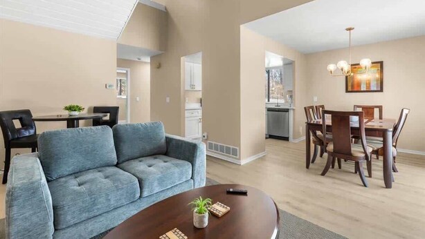 A modern apartment with a living room, dining area, and kitchen. - NEW Corp/Bus Townhome New Hudson (New Hudson)