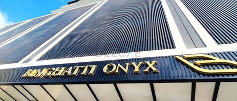 A modern hotel facade with the name 'BANGHAITI ONYX' prominently displayed.