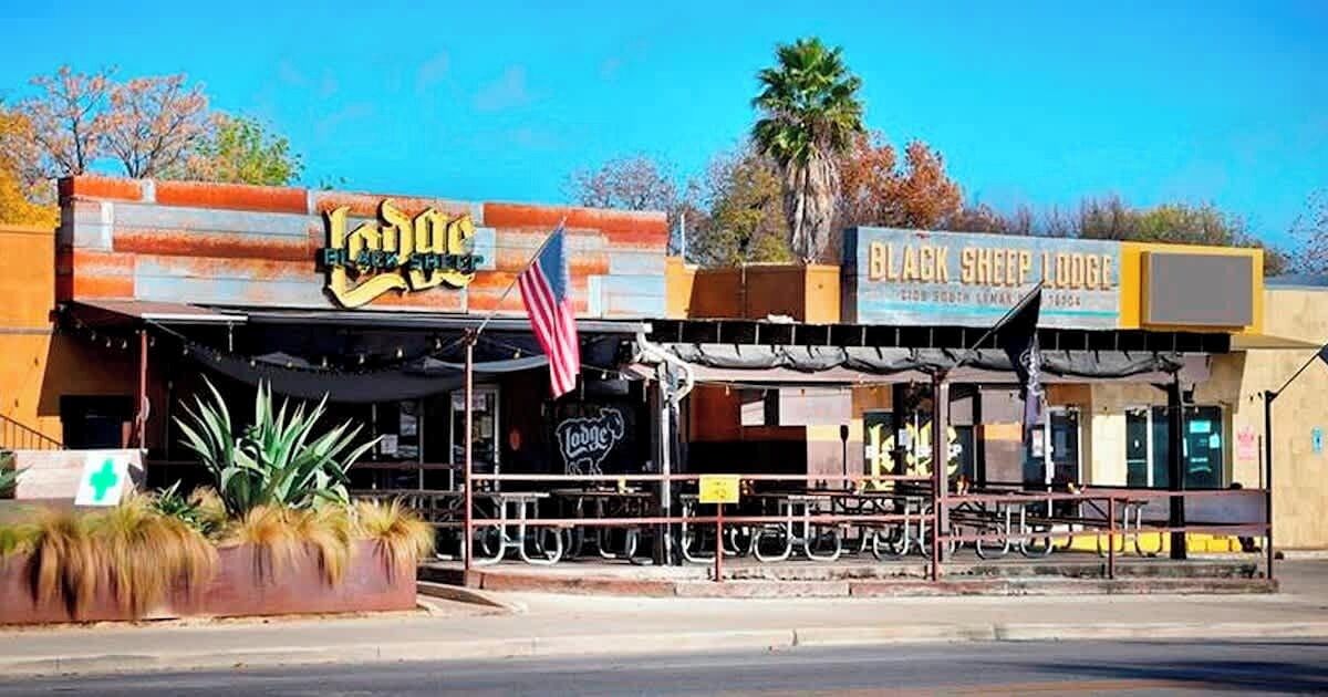 A building with a sign that reads "Black Sheep Lodge."